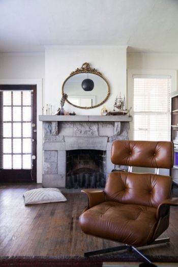 Stunner midcentury leather chair, stone fireplace as a happy place on surroundedbypretty.com
